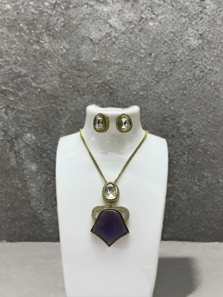 Jewelry set with necklace and earrings on a white stand against a gray background